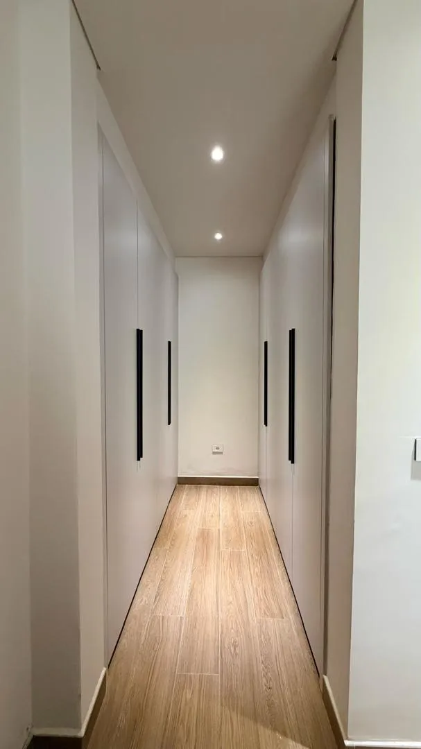 Residence hallway with warm timber flooring